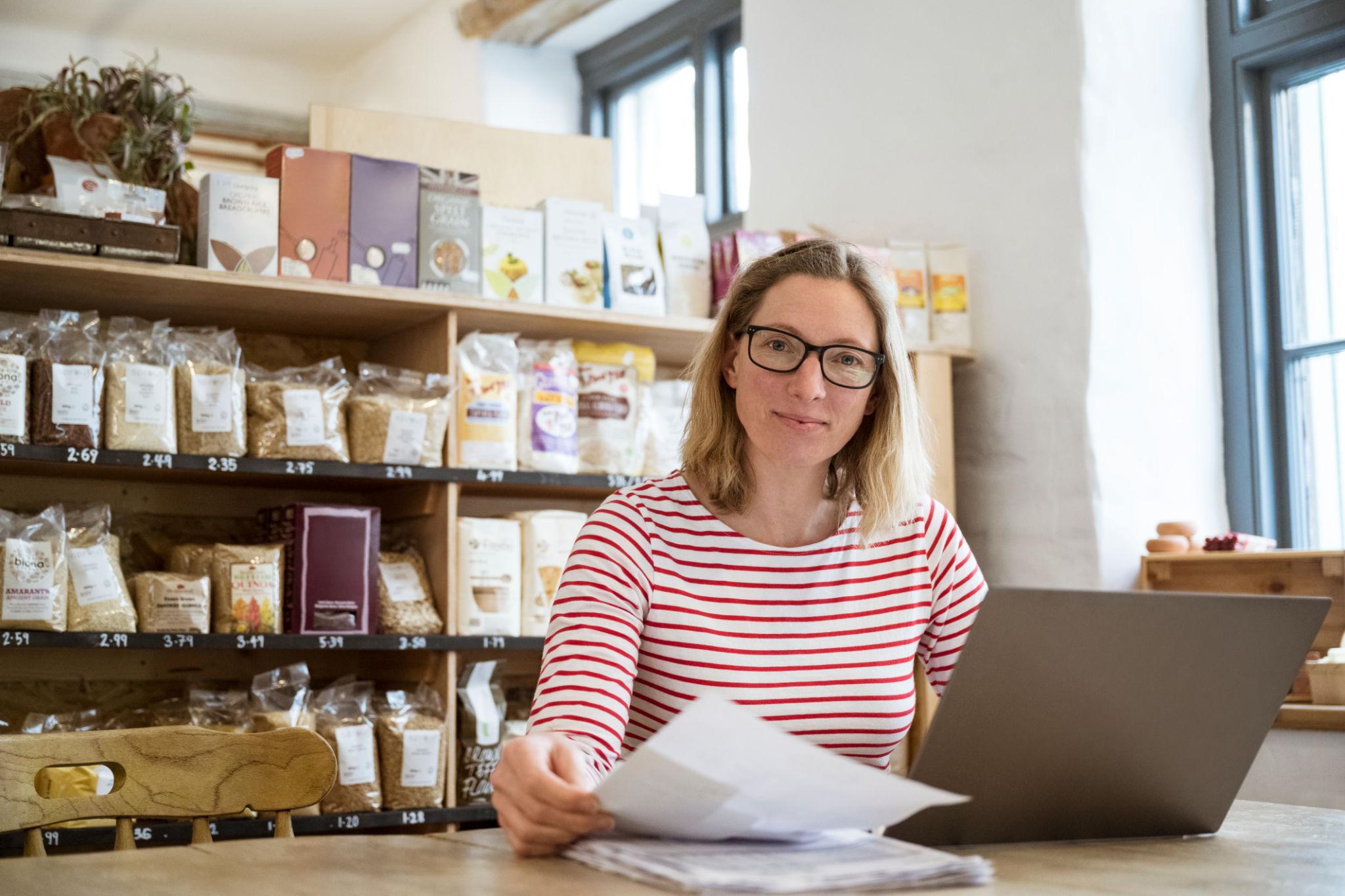 Woman working on laptop in a store